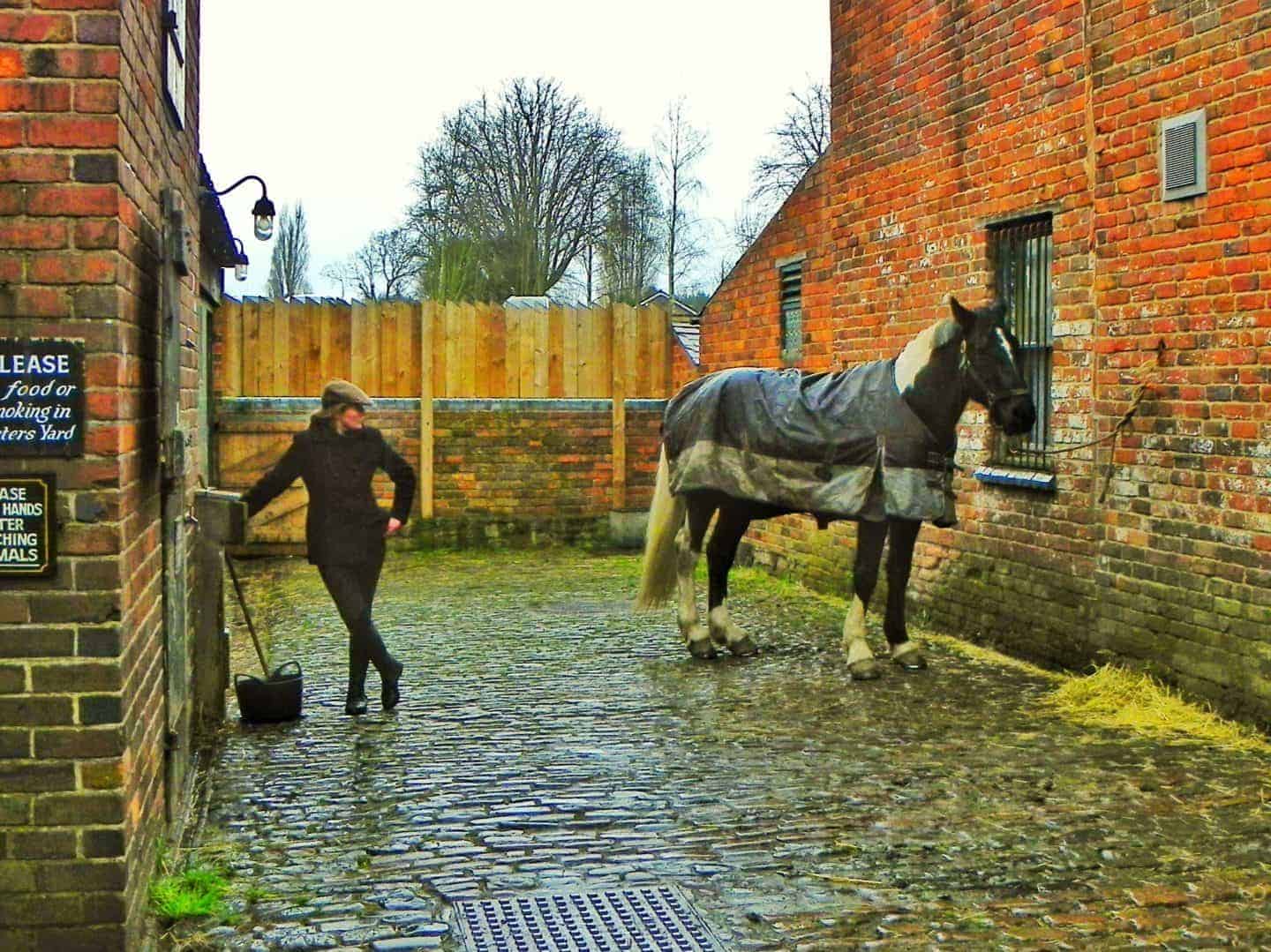 Female historical character with a horse at the Black Country Living Museum near Dudley in the West Midlands. This is a living history museum that is perfect for visitors of all ages from small children to adults. It is an excellent, full day out with both food outlets and picnic areas available. Includes the Dudley Canal and Tunnel Trust.