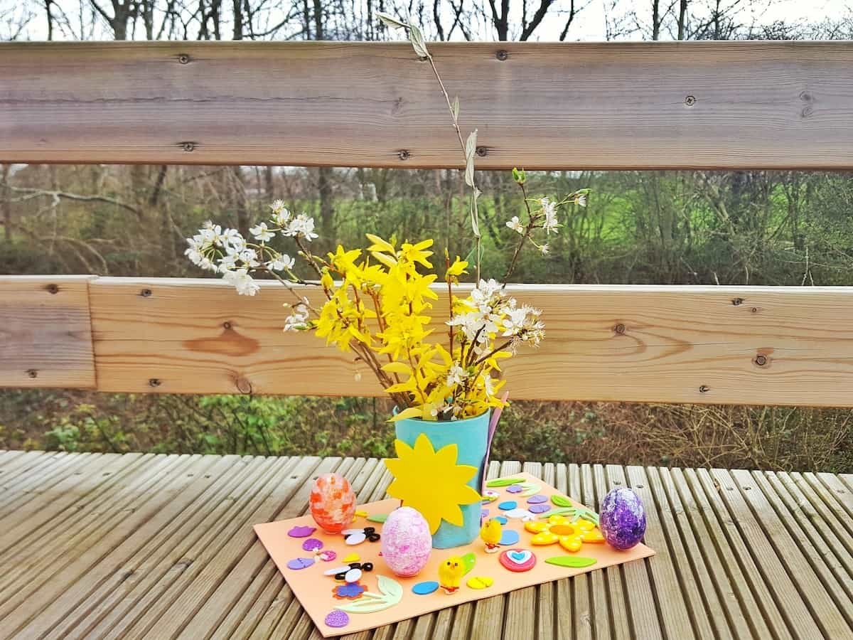 Craft for children - an easy Easter table decoration. This is a great craft for kids to get involved with. There are simple bits for them to do such as fixing stickers on, while you can get on with the more complicated bits like glueing and sticking. This craft incorporates nature and allows you to bring a little bit of Spring into your home this Easter.