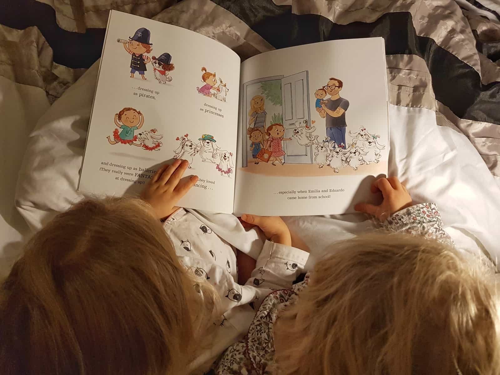 Overhead photo of two little girls reading The Great Cat Nap