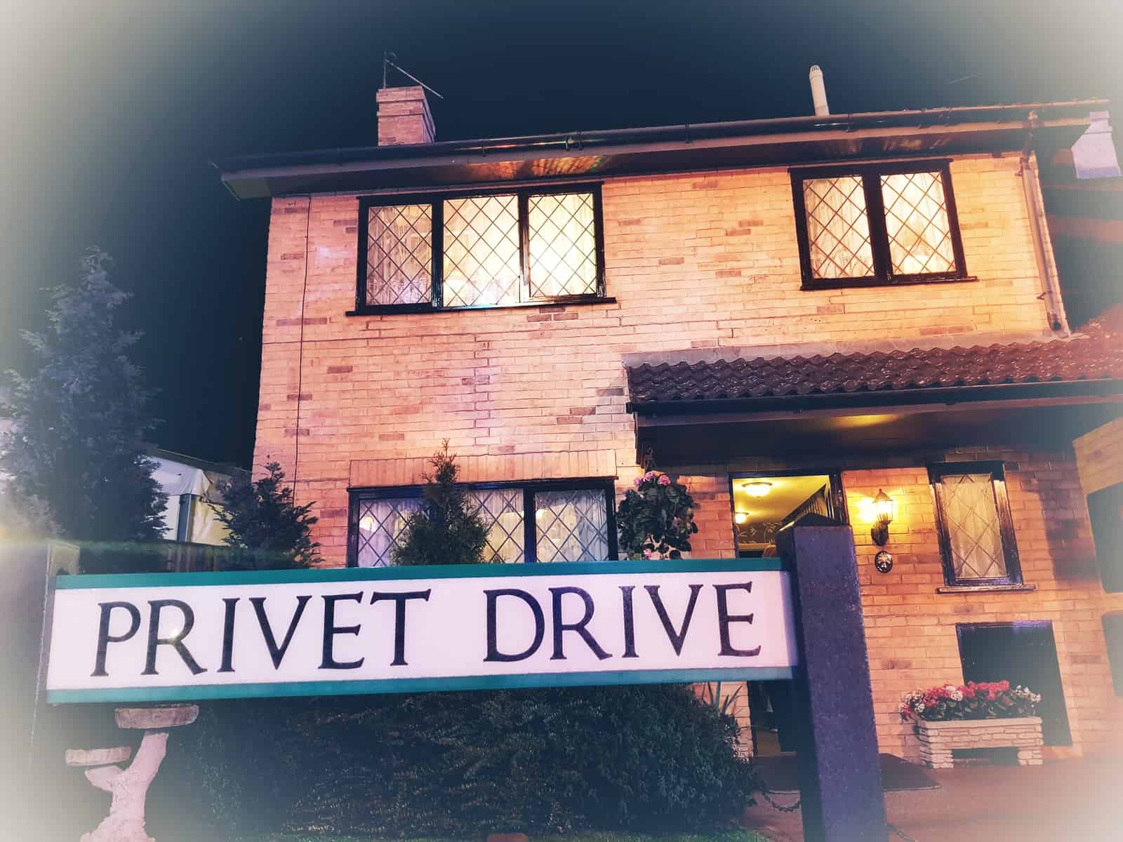 The outside of 1 Privet drive with the Privet Drive sign in the foreground
