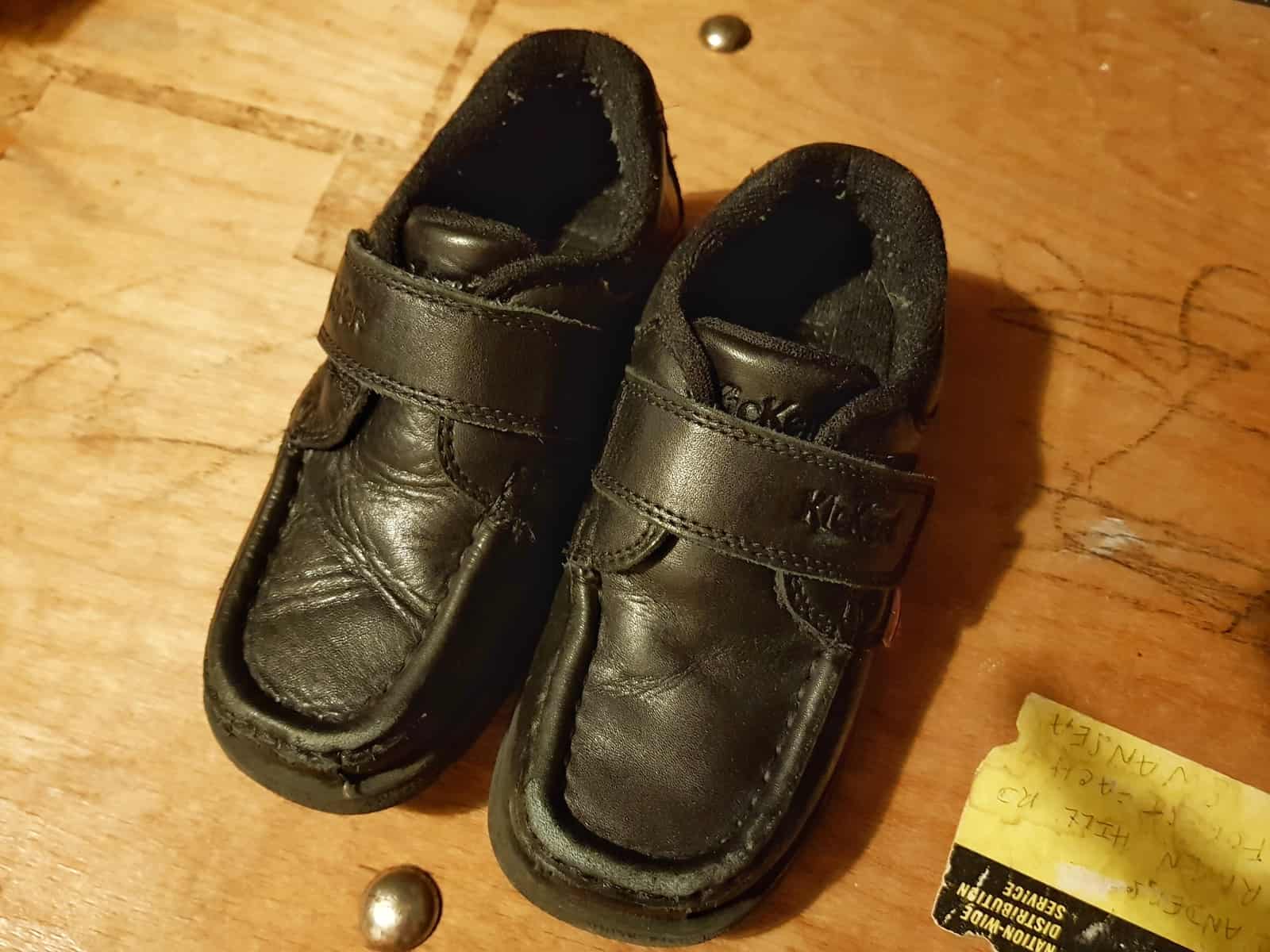 Black boys loafers school shoes on a wooden surface