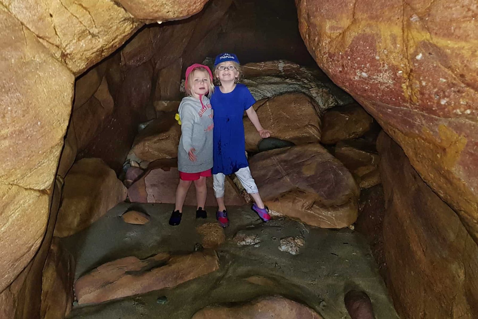 Two little girls in a cave on Porthsele, a Pembrokeshire beach near Pencarnan farm