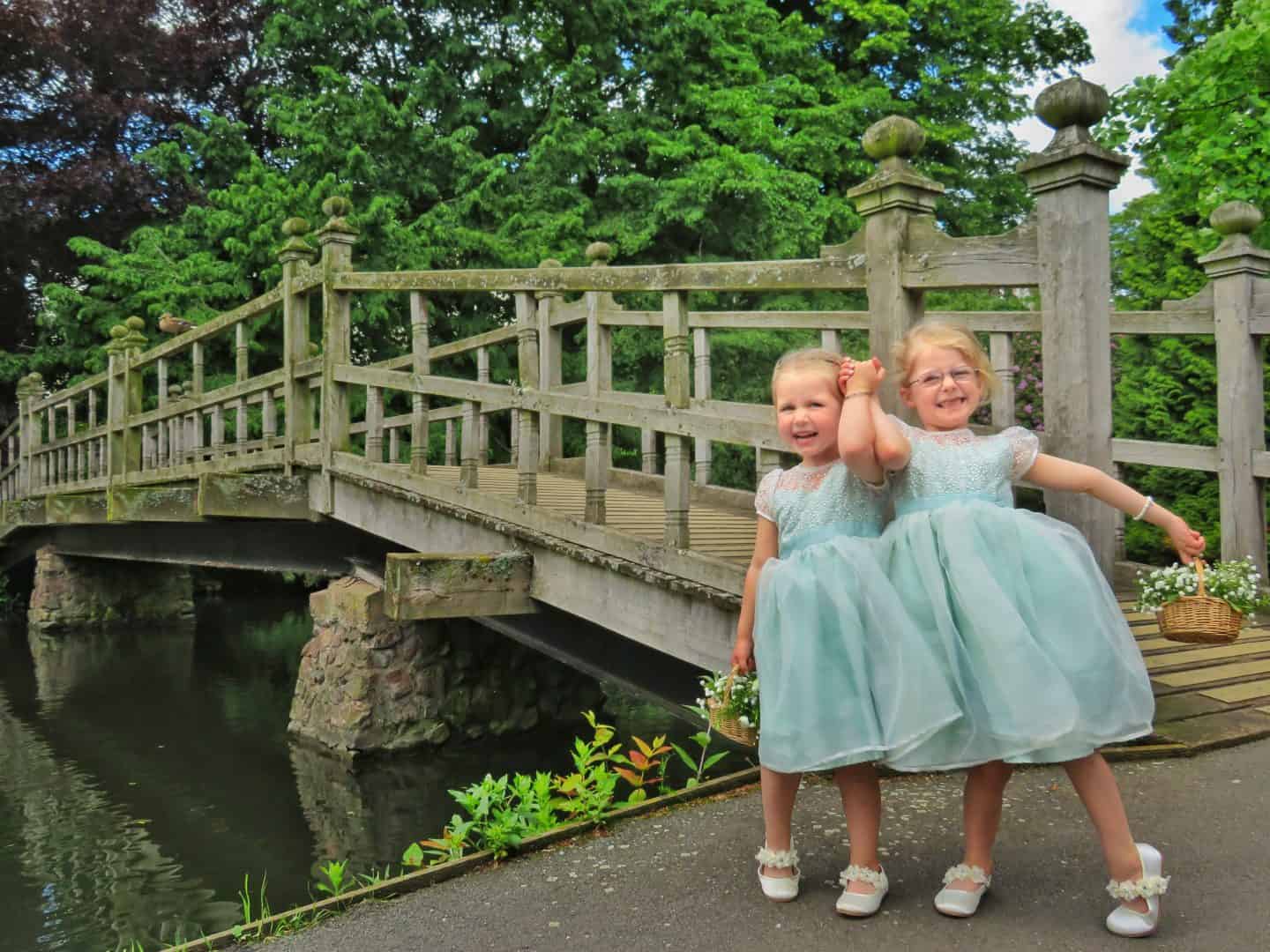 Two girls standing in front of the Priory Park bridge, a free park in Great Malvern