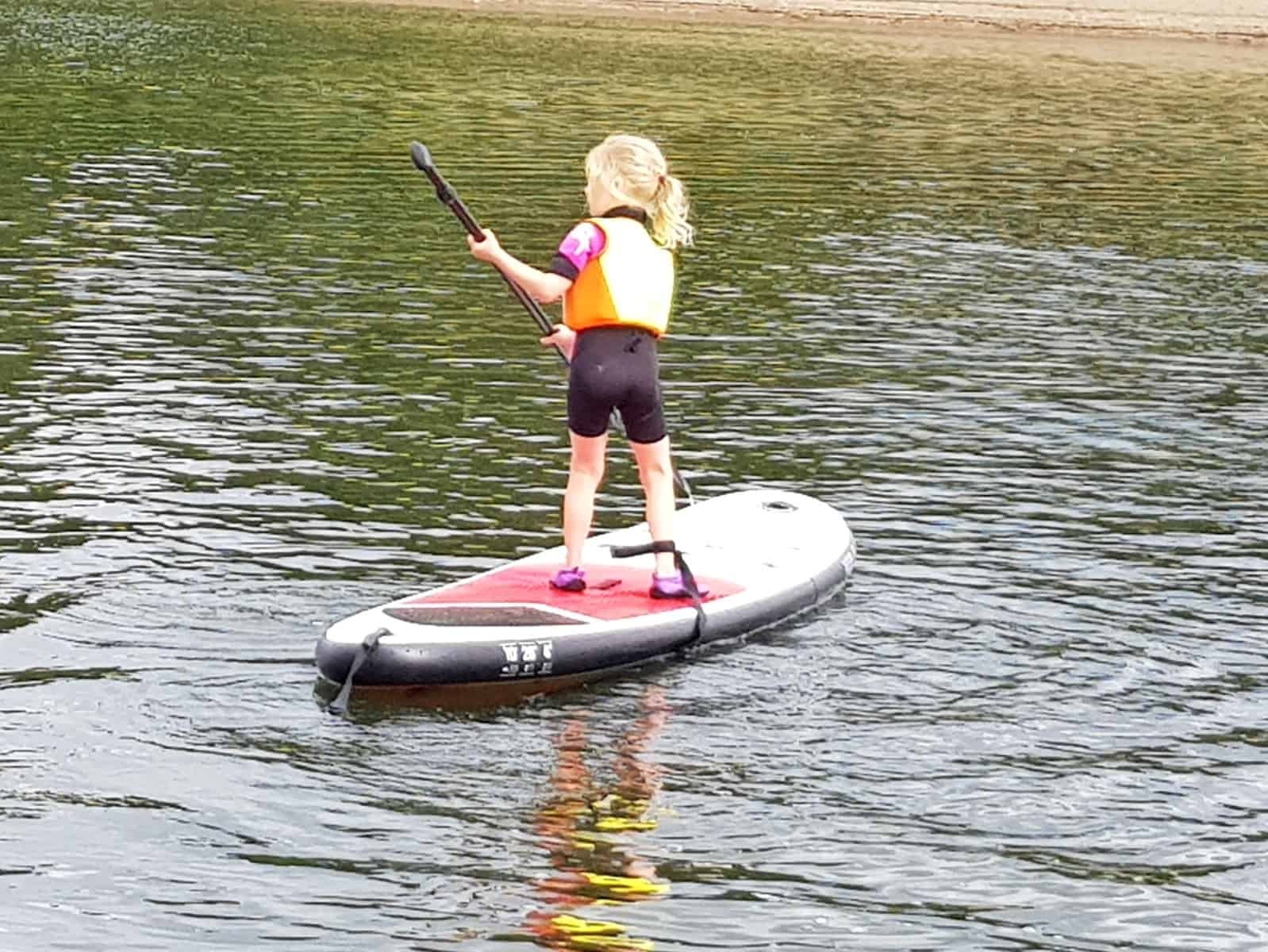 Little girl paddleboarding at Wimbleball Lake