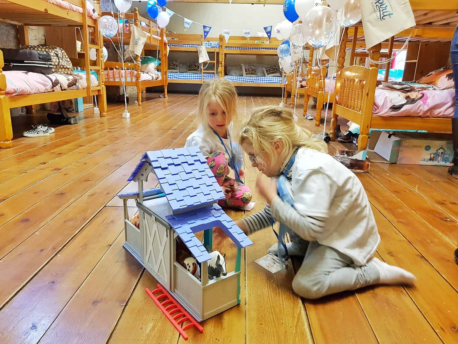 Spirit Riding Free Stable Sleepover girls playing with stable toy in dormitory