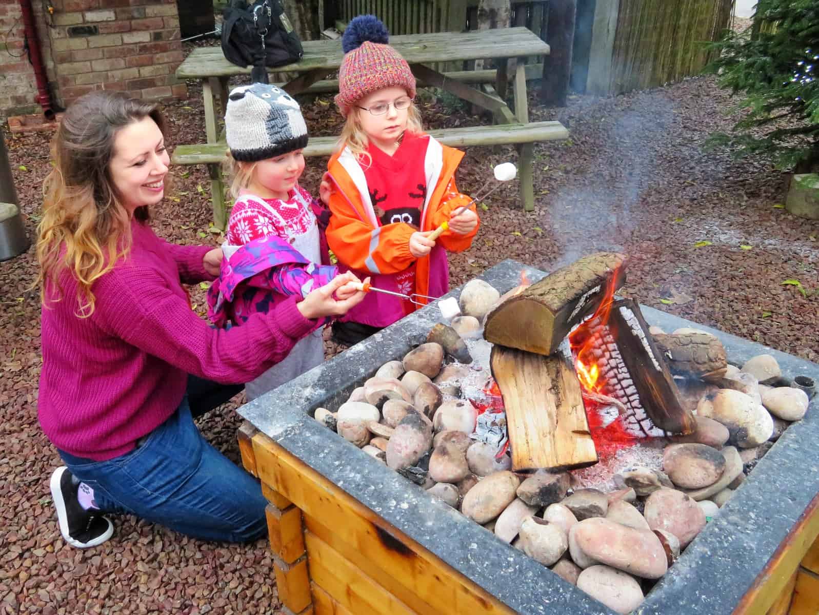 Santa Drive Eastnor Land Rover mum and two girls toasting marshmallows
