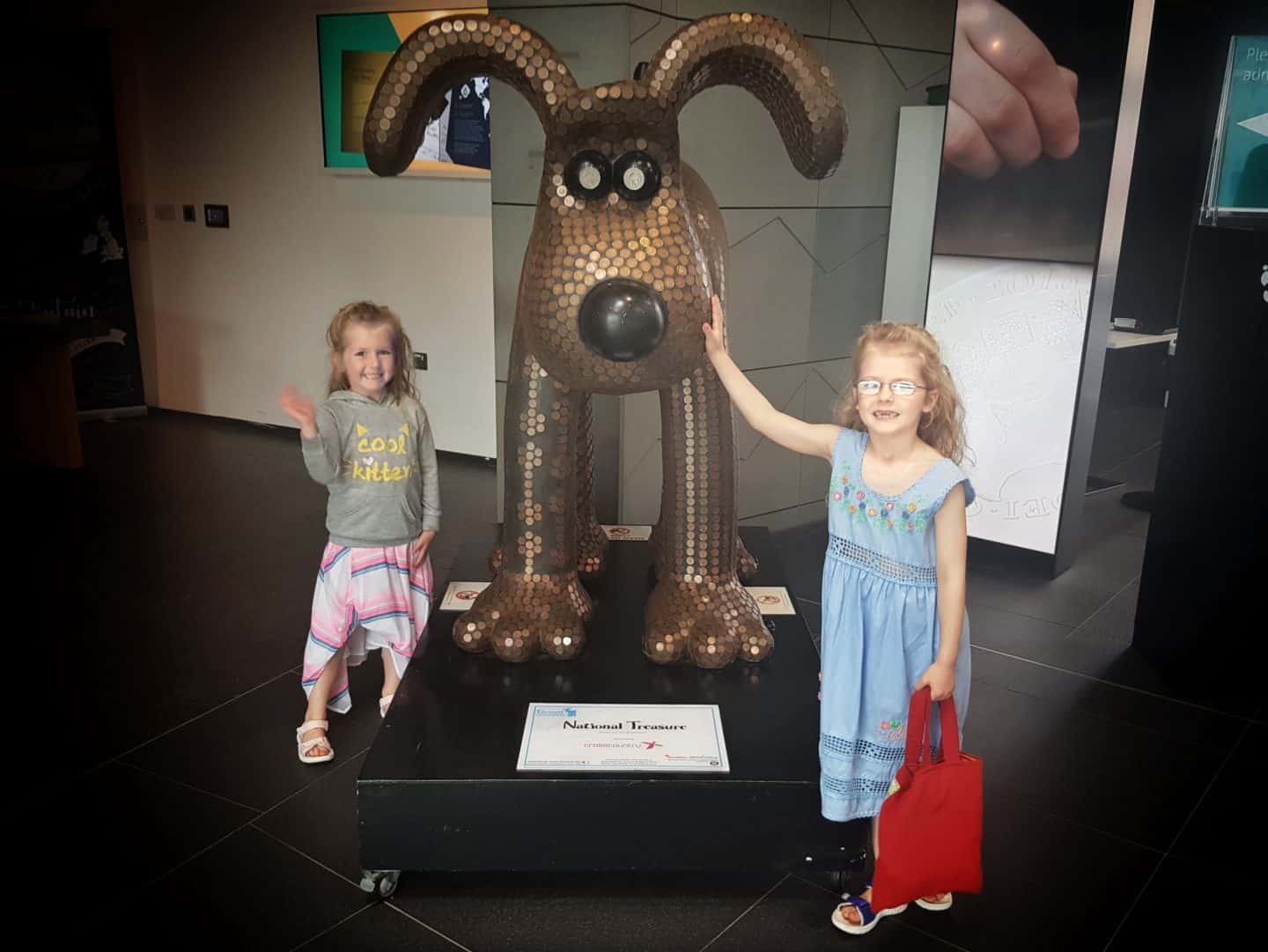 girls by dog statue at Royal Mint Experience