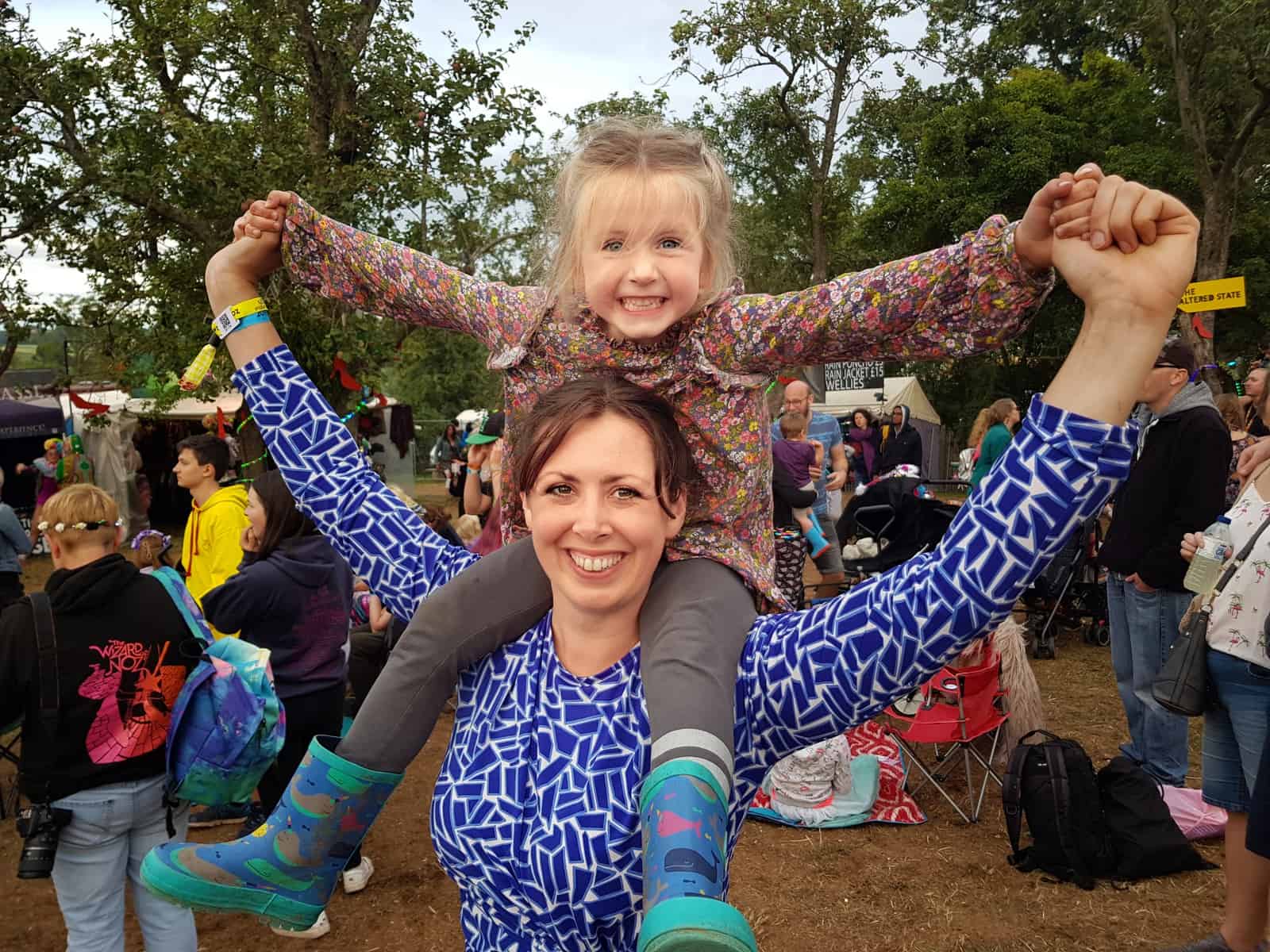 Mum with little girl on her shoulders at Nozstock The Hidden Valley Festival