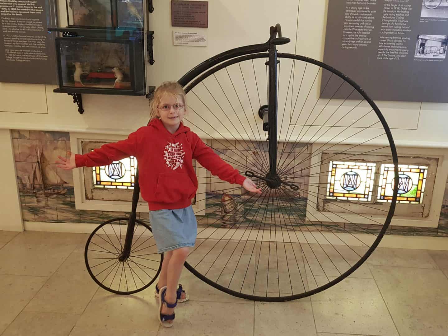 girl with Penny Farthing at Winchester city museum