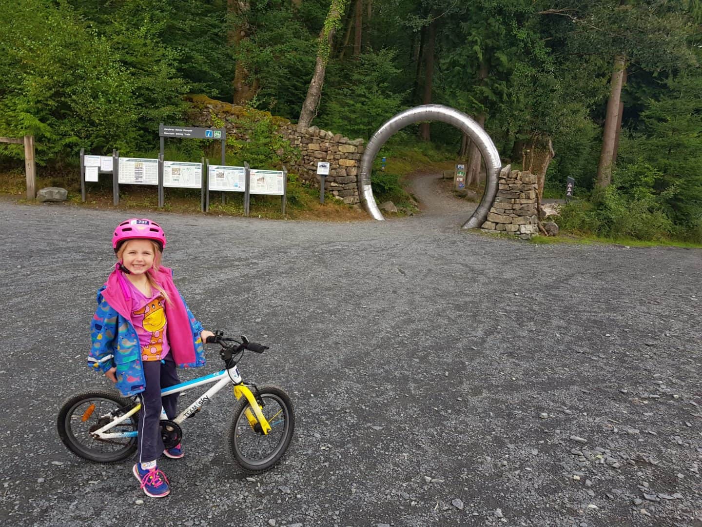 Child about to start cycling the family trail at Coed y Brenin Forest Park