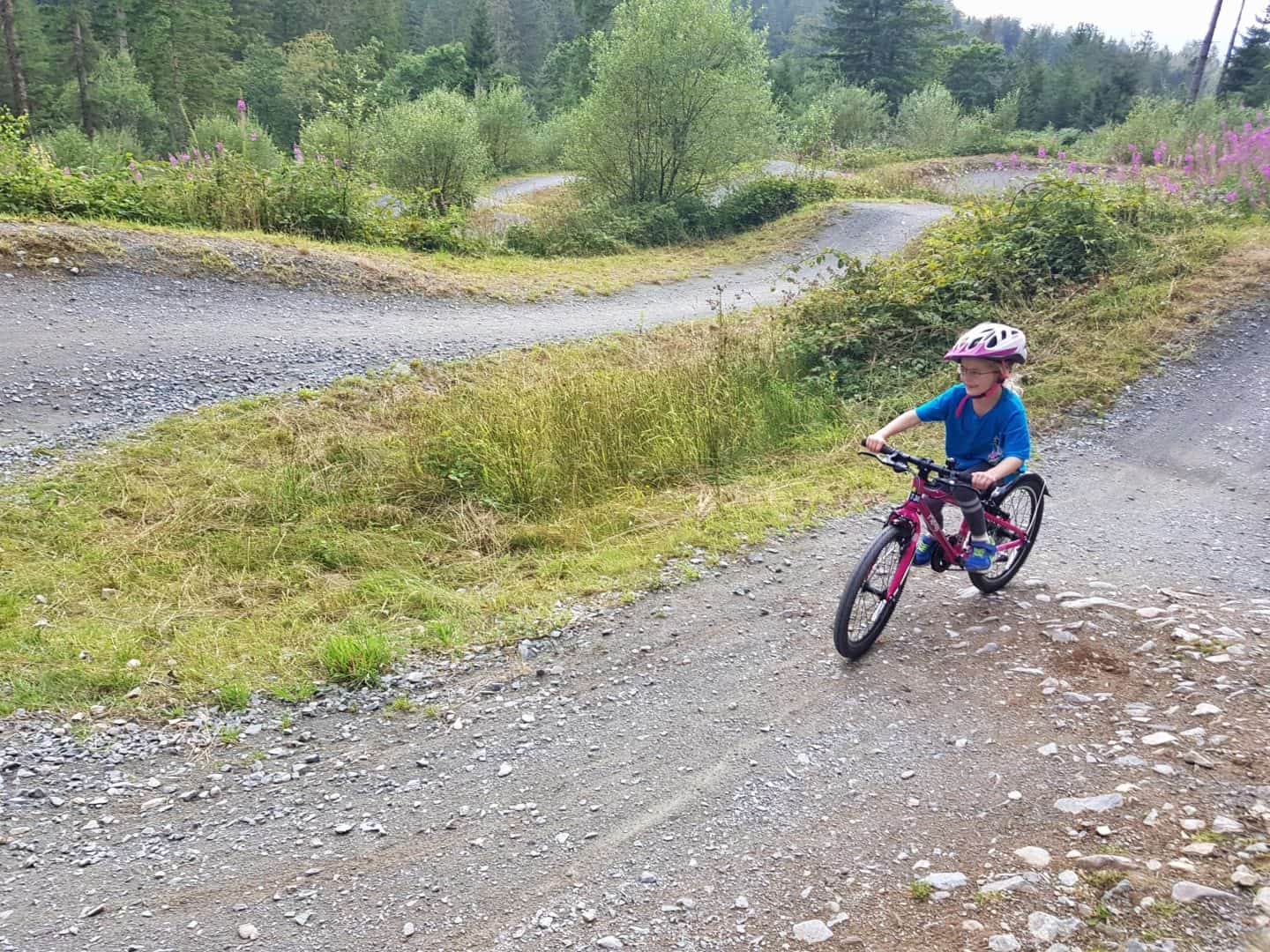 Young girl cycling on mtb skils area at Coed y Brenin Forest Park