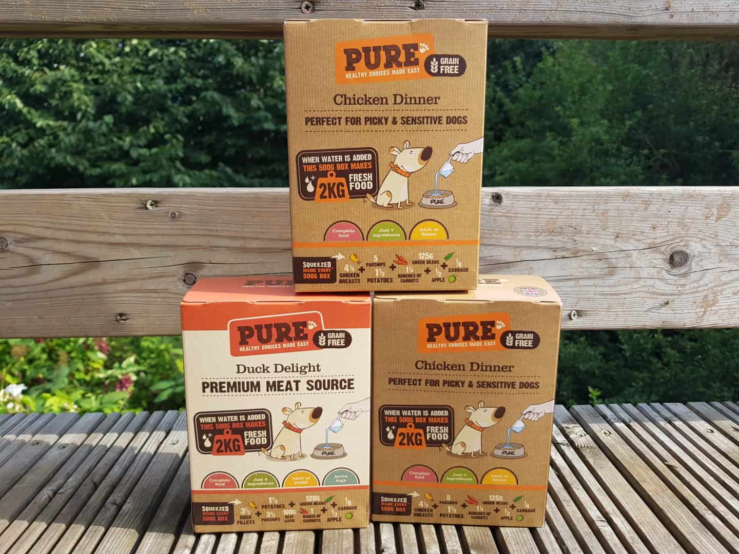 Three boxes of Pure dog food