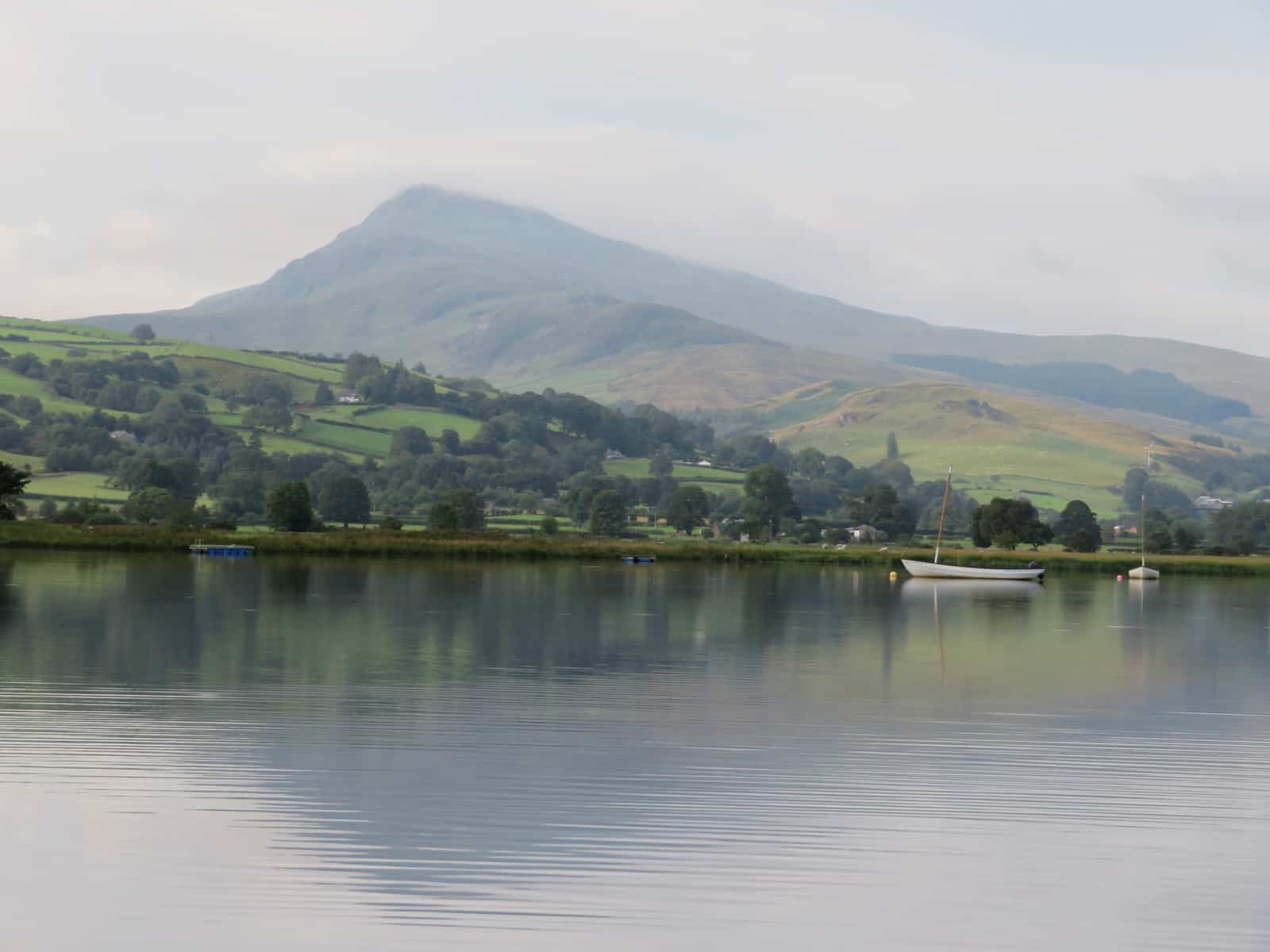 Lake Bala, North Wales in foreground with mountain behind, top in cloud