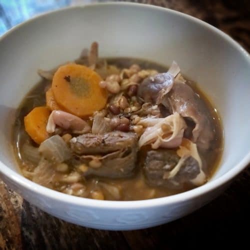 white bowl containing mushroom stew with Opies pickled walnuts