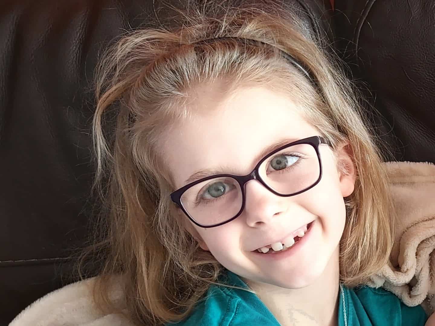 Little girl wearing glasses and smiling