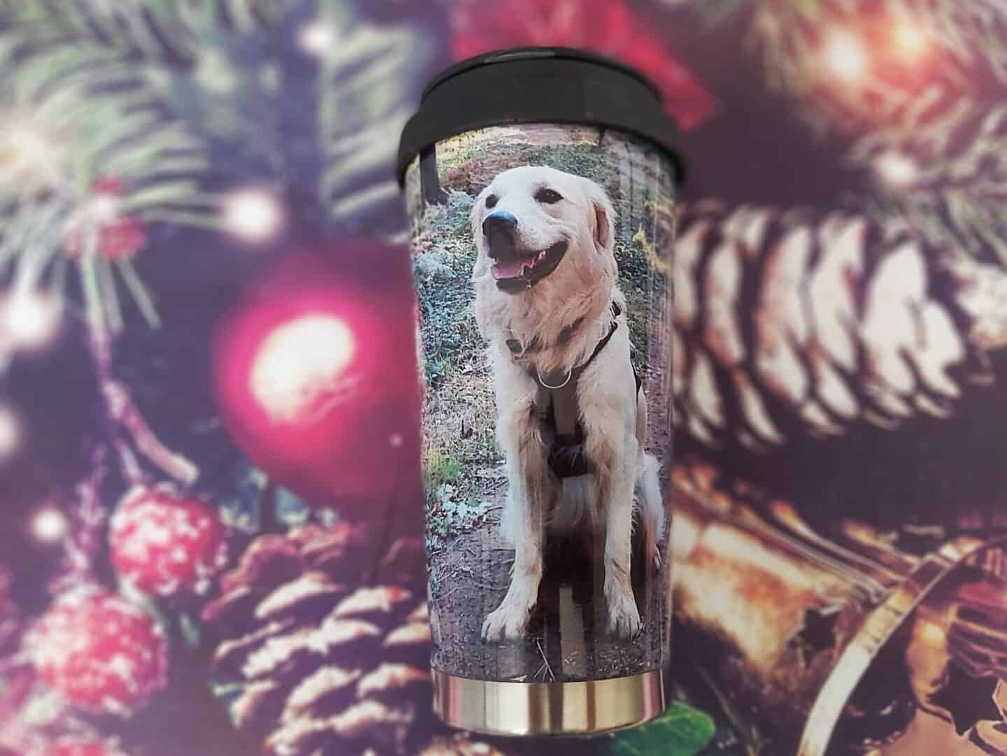 Personalised Travel Mug with a golden retriever on it with a festive background of pine cones and a bell as a Christmas gift for dog lovers 