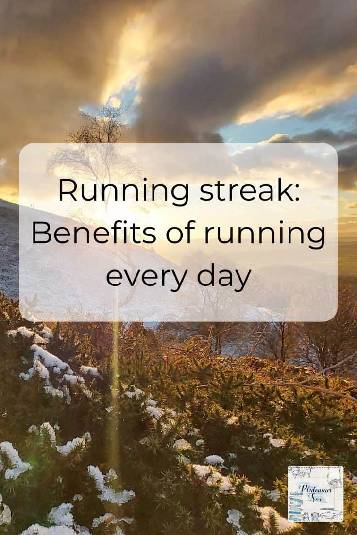 Pinnable image with text: Running streak: The benefits of running every day on top of image of a wintery sunset