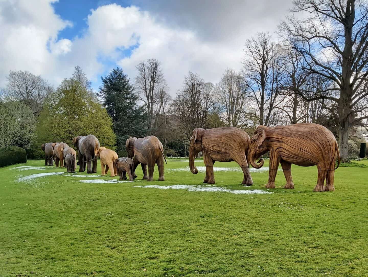 Herd of elephant sculptures walking away