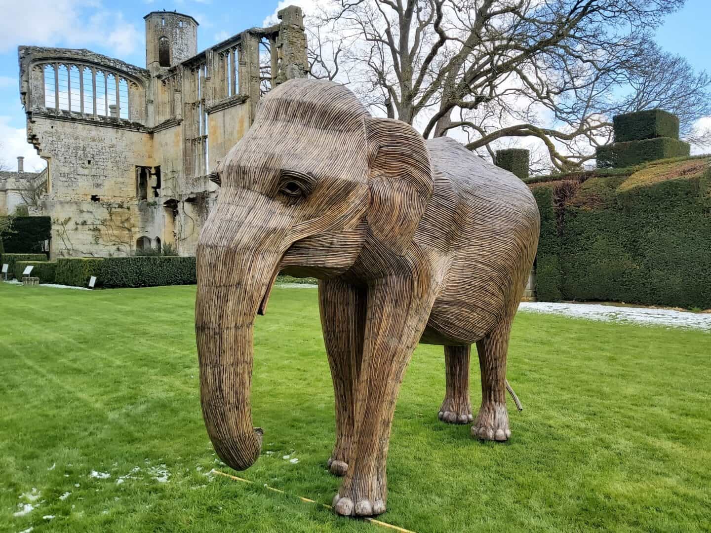 Elephant sculpture with Sudeley Castle ruins in the background