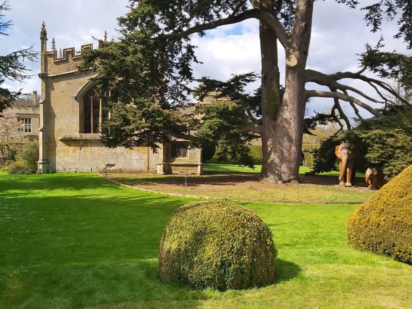 Elephants under a tree by St Mary's Church in Sudeley Castle Gardens