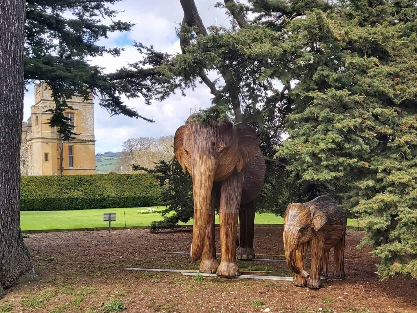 Elephant sculptures under a tree in Sudeley Castle Gardens