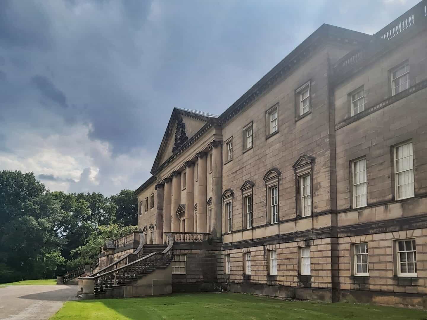 Family road trip from the West Midlands to the Scottish Highlands breaking up the journey from the West Midlands to North Yorkshire at National Trust Nostell. Photo of Nostell. Huge building with grand stairs at front.  