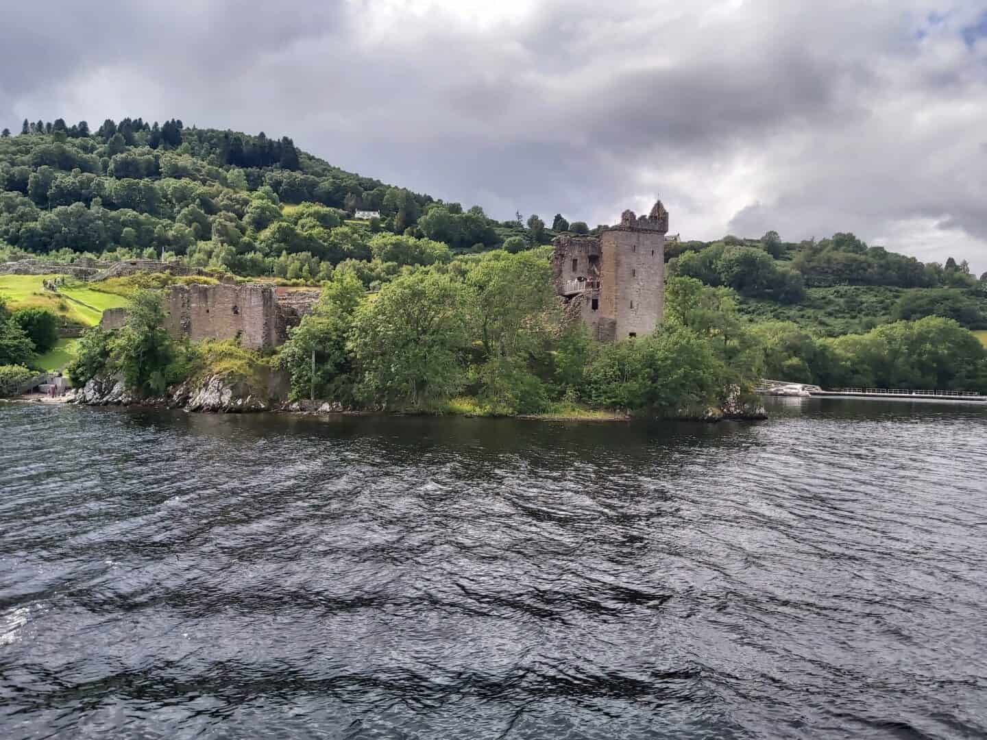 Urquhart Castle on Loch Ness. Photo taken from a boat with loch in foreground.  