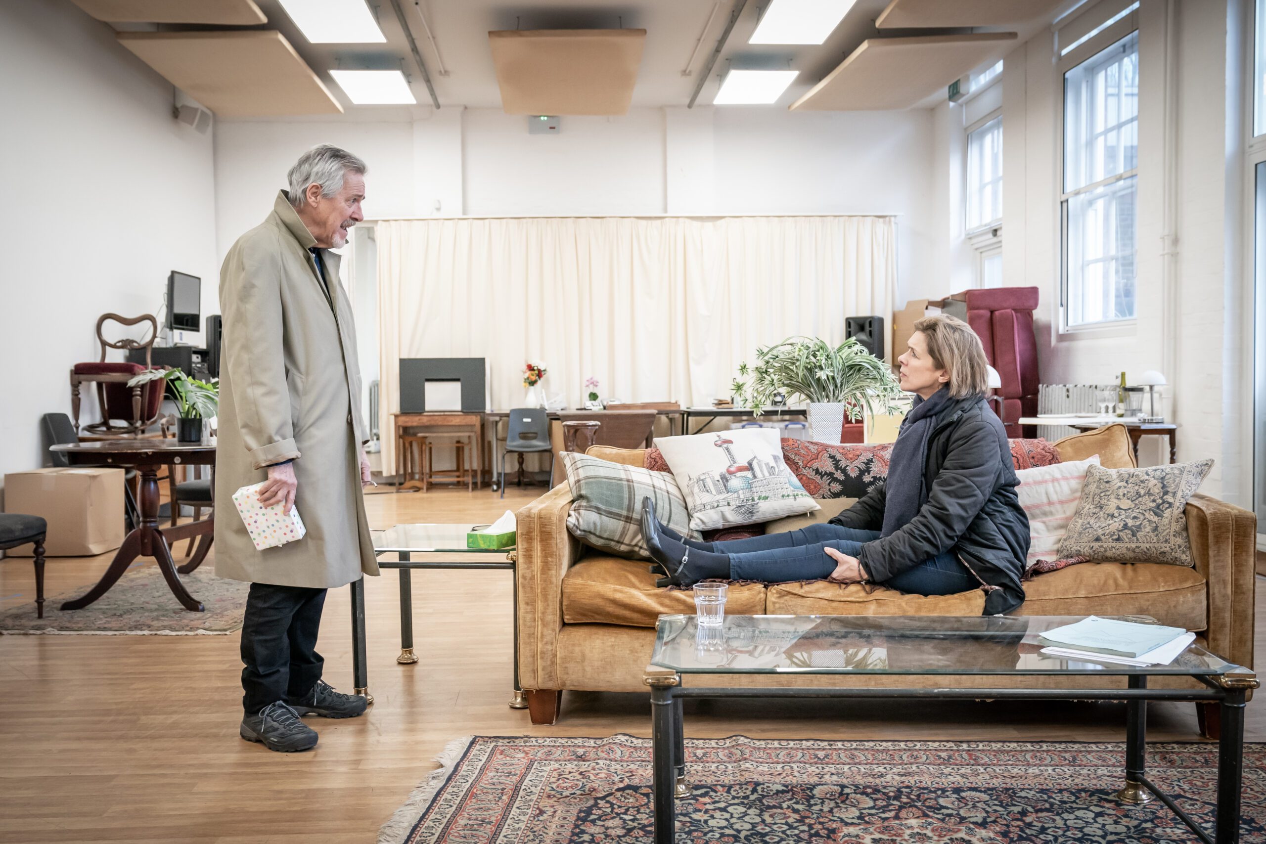 Actors Janie Dee and Griff Rhys Jones pictured in a set designed as a living room playing Laura and Peter in An Hour and a Half Late currently showing at Malvern Theatres