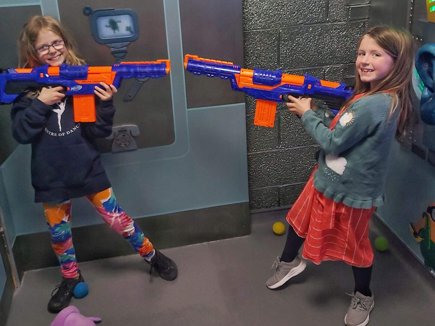 Children with nerf guns pointed at each other at CyberQ escape rooms an ideal day out for a rainy day during Worcestershire school holidays