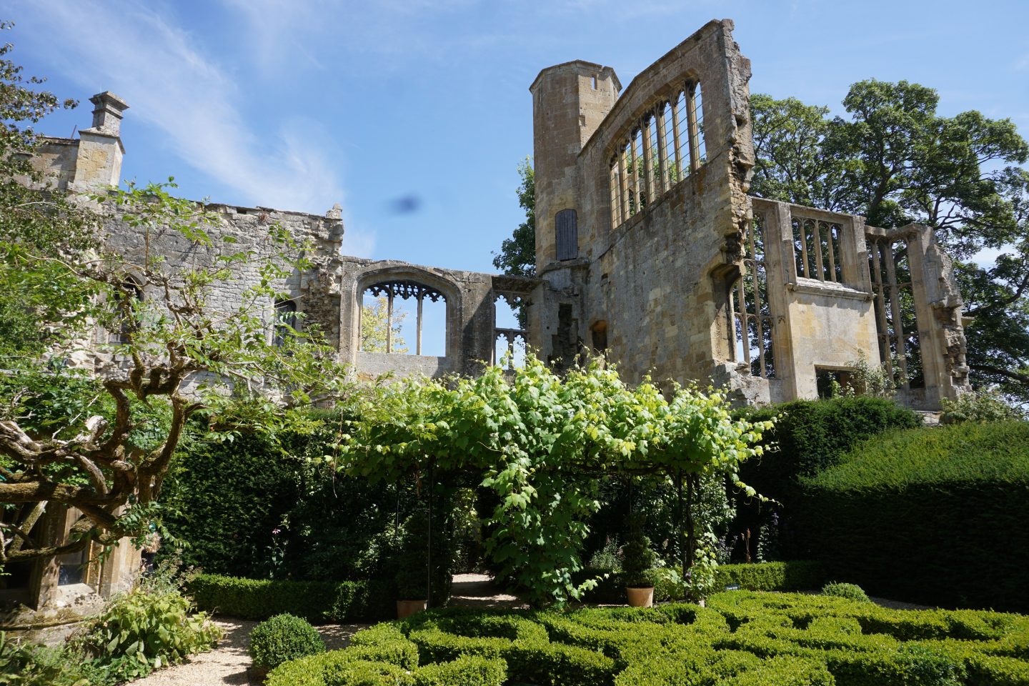 The knot garden at Sudeley Castle with the castle's ruins in the background
