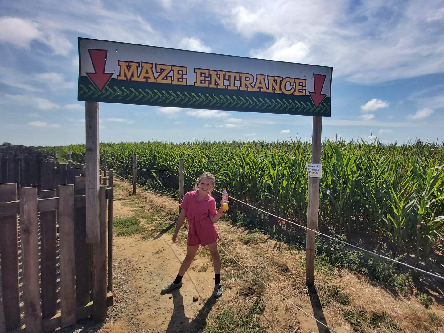 Girl by the entrance to the maize maze at Hirsty's family fun park