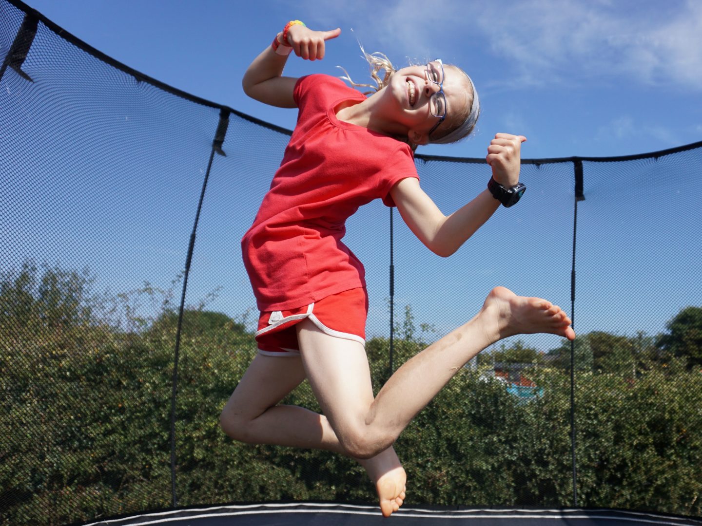 Girl jumping high on a trampoline at dog friendly Hirsty's Family Fun Park