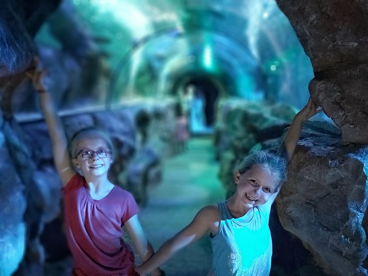 Two girls inside the entrance to an ocean tunnel at Sea Life Centre Great Yarmouth