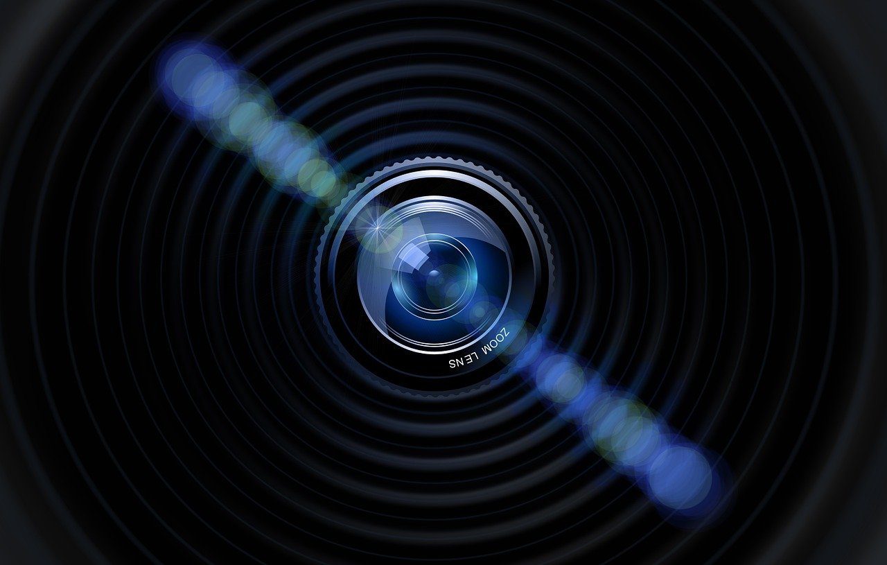 close up image of a camera lens with a line of light emanating from the centre towards top left and bottom right of the image
