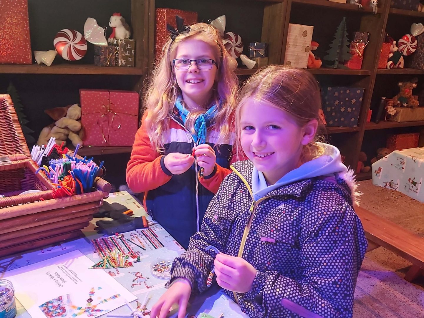 Two children sitting at a craft table in the personalised Santa Experience at Winter Glow