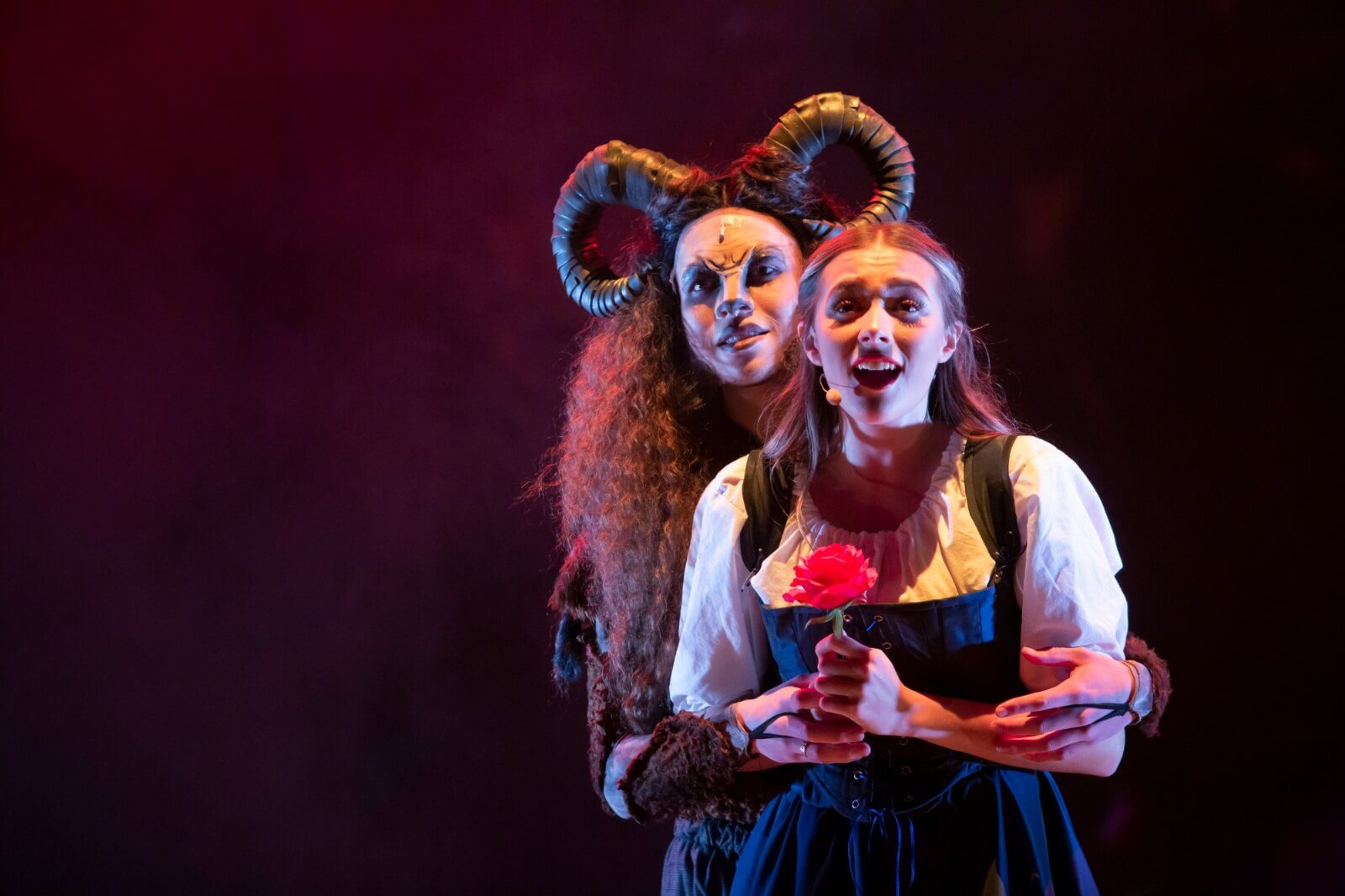 Belle and the Beast in Beauty and the Beast at the Old Rep Birmingham standing together with a rose