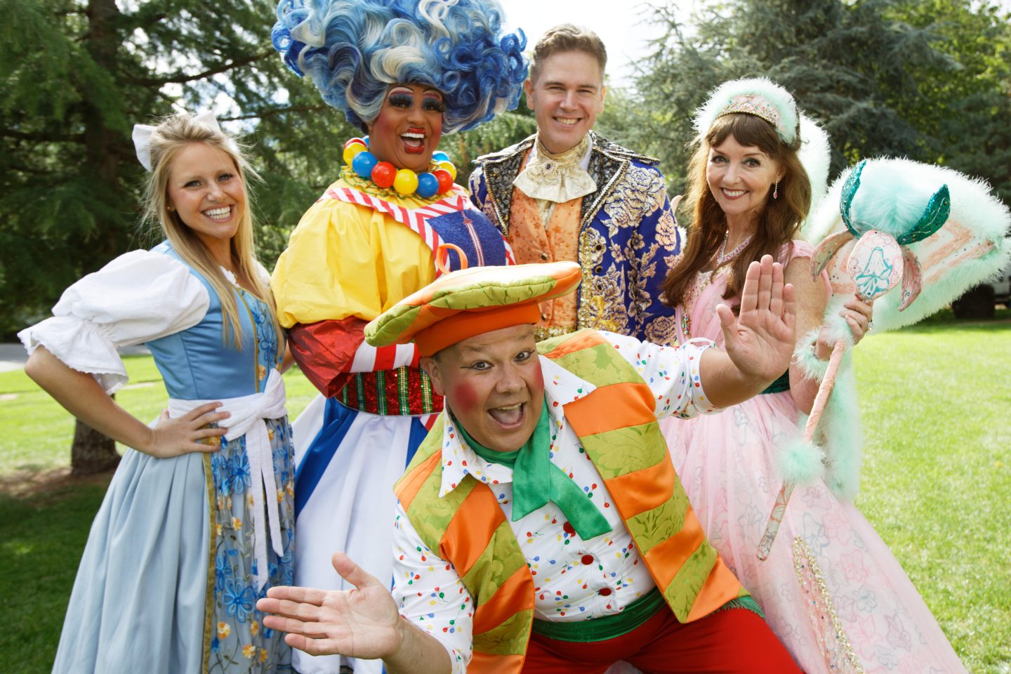 Beauty and the Beast Pantomime at Malvern Theatres cast with Mark James at the front taken outdoors with green grass and trees behind