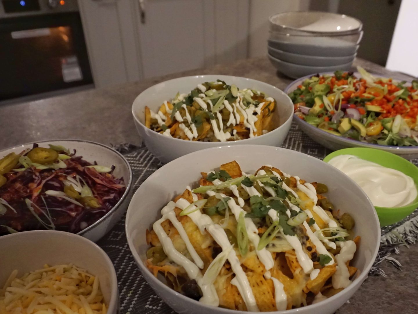 Bowls of Mexican food prepared by yhangry chef Dean on a grey table with kitchen in the background