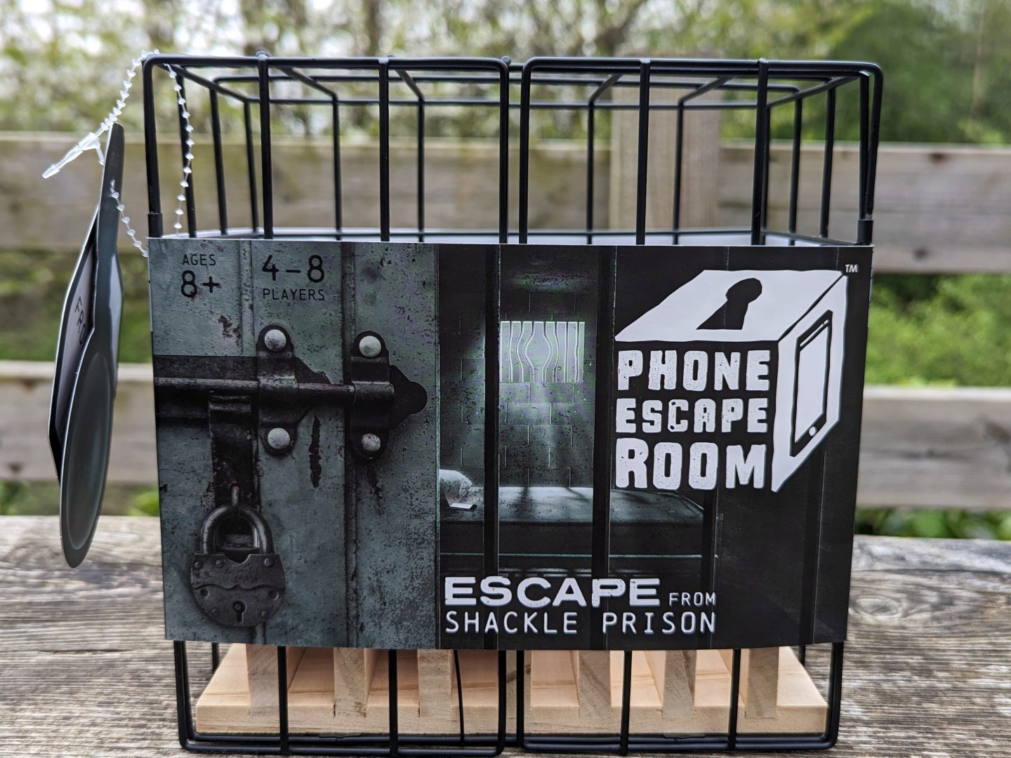 Phone escape room cage with packaging still on - a traditional toy for kids that lets them solve puzzles to get to their electronics