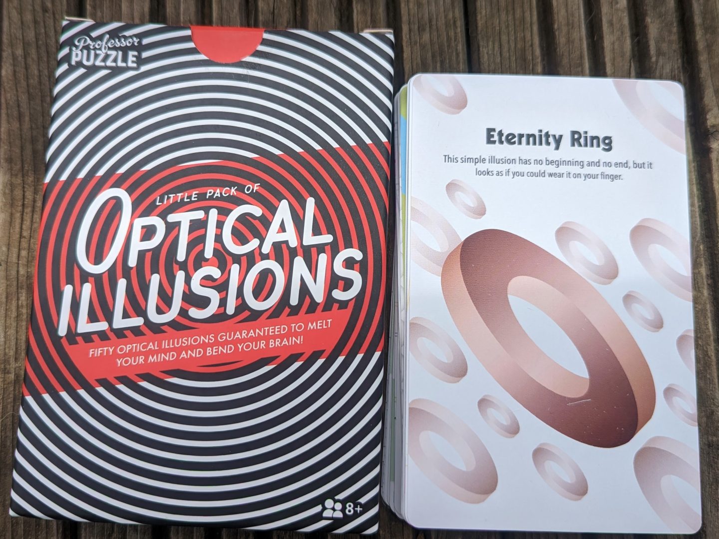 Optical illusions cards box and card next to it with an eternity ring optical illusion