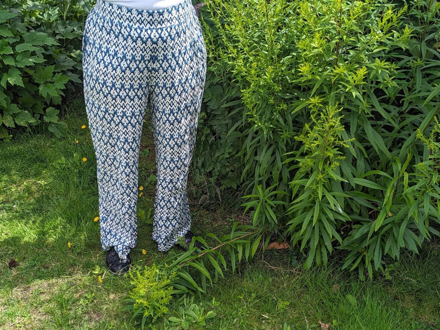 Natalie photographed from the waist down wearing Cotton Traders Jasmine Harman Collection blue and white printed trousers