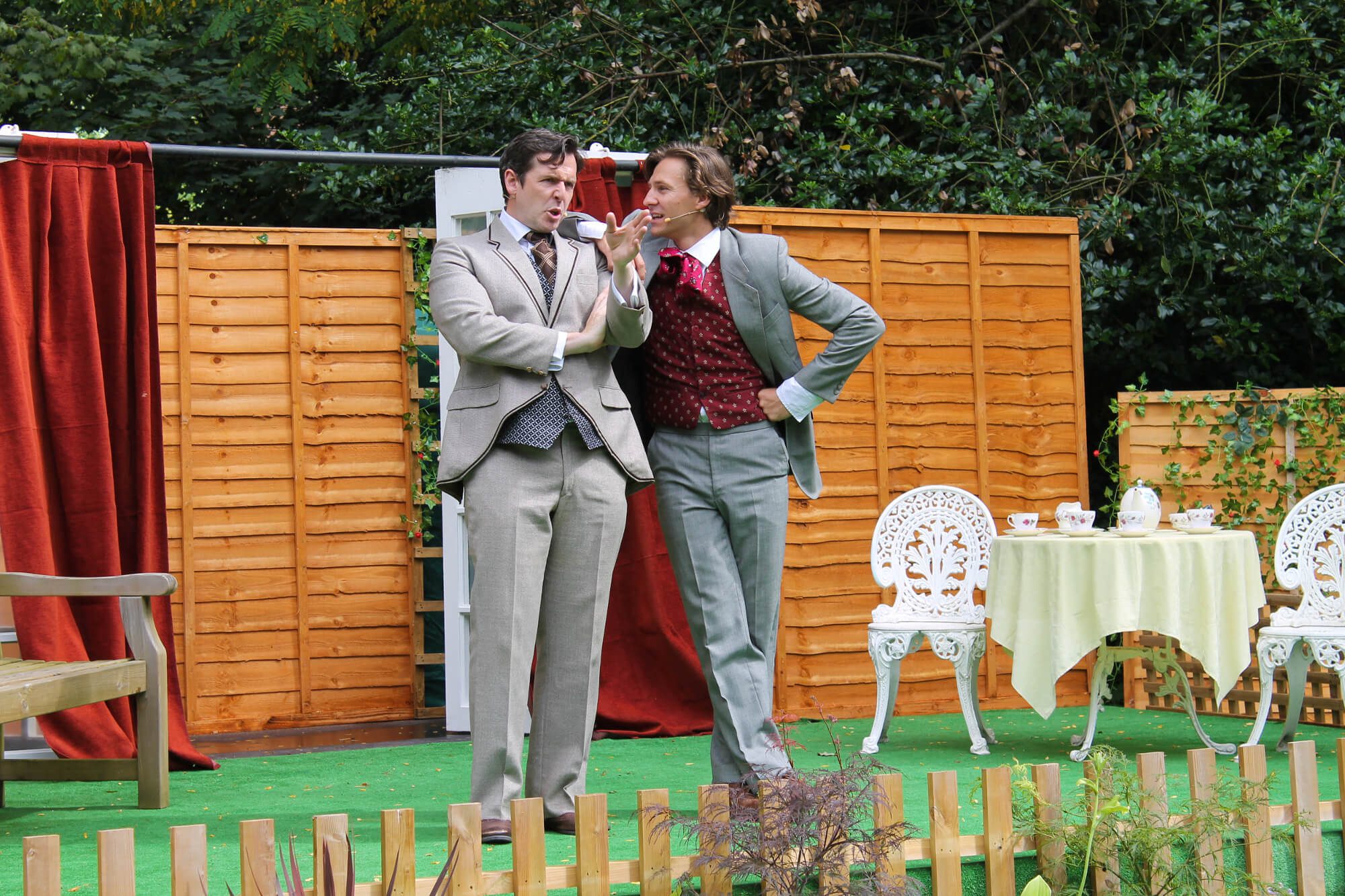 Two male characters Jack and Algernon on stage in The Importance of Being Earnest in Worcester Commandery Gardens outdoor theatre