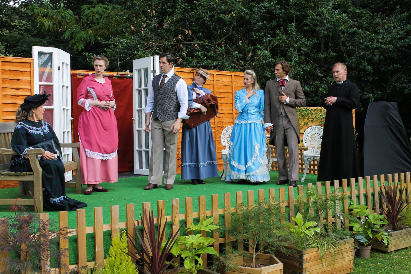 Characters on stage in The Importance of Being Earnest in Worcester Commandery Gardens outdoor theatre