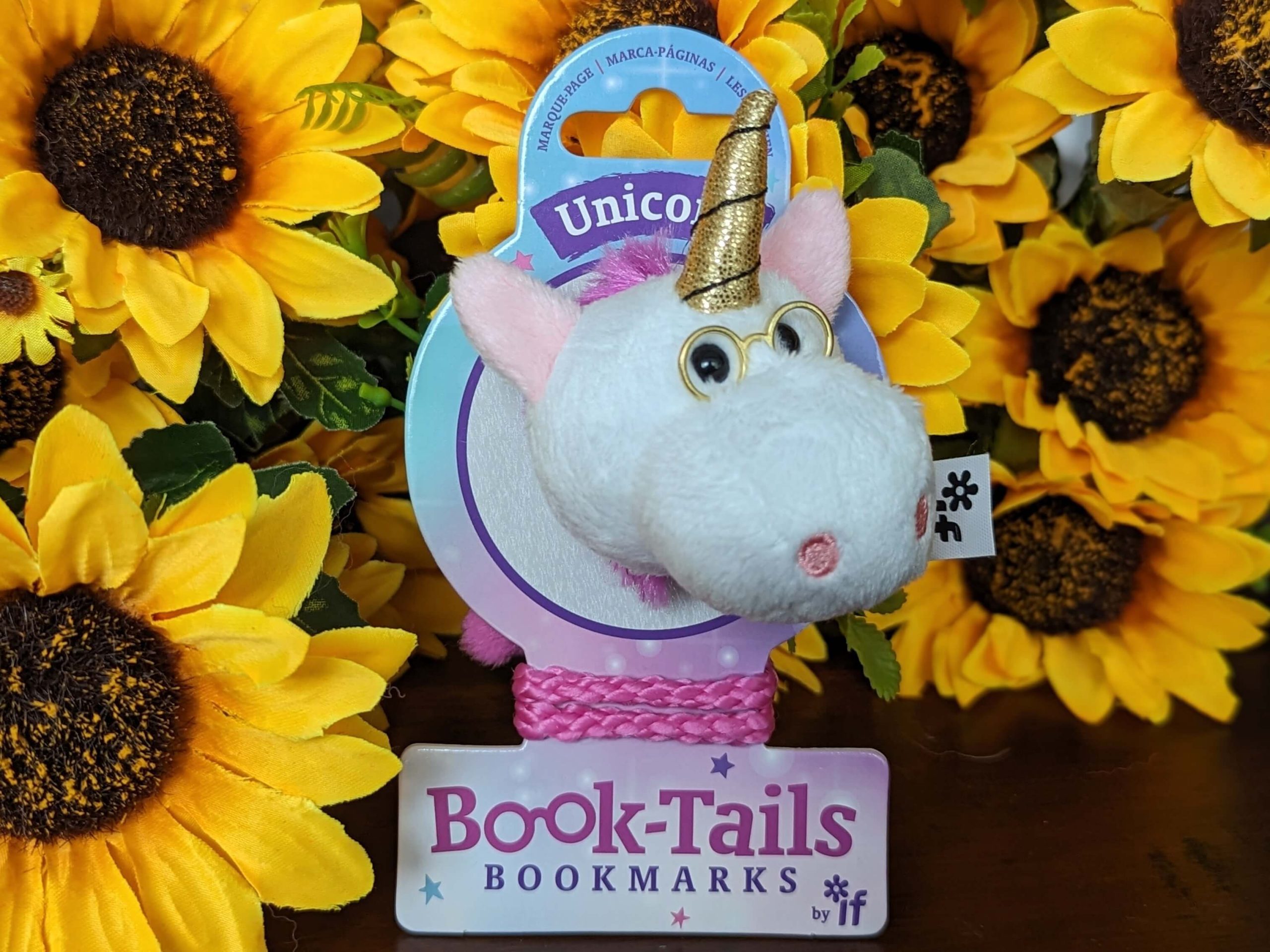 Unicorn bookmark ideal stocking filler for book-loving kids displayed against a bunch of sunflowers