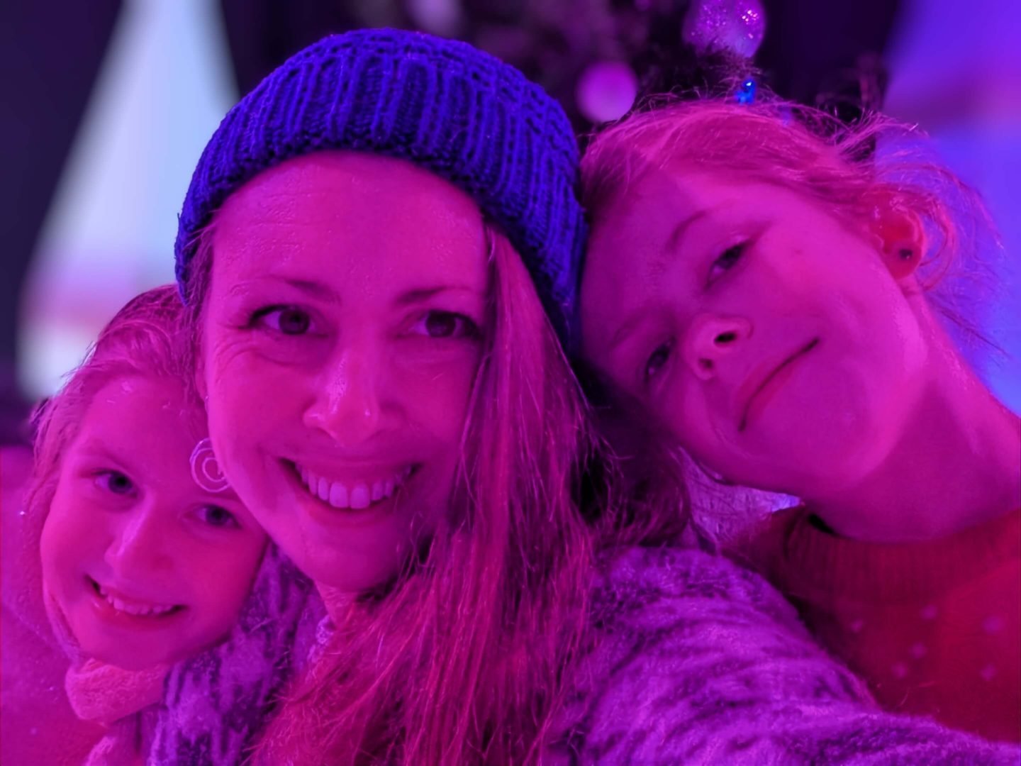 Selfie of a mum and two girls on the winter glow ice rink