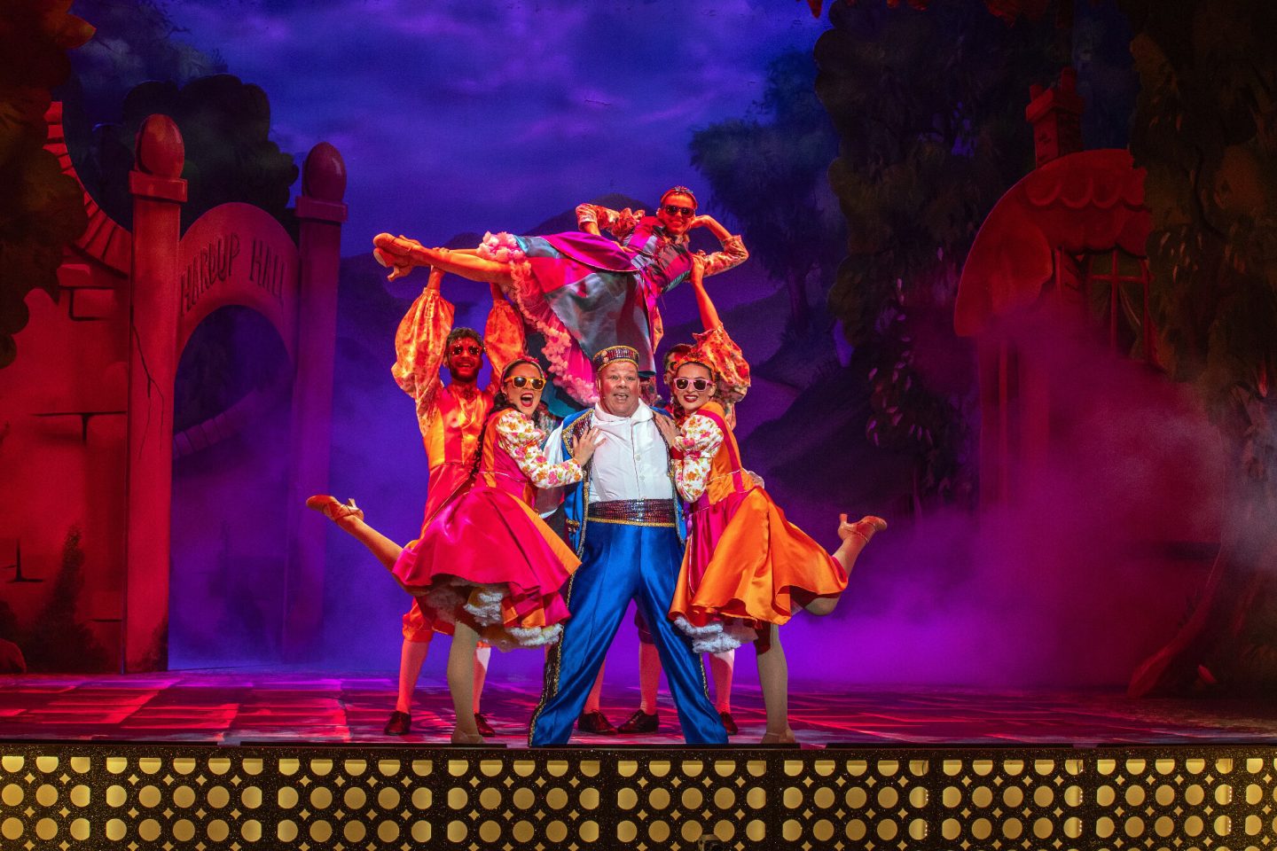 Mark James on stage with other cast members in Cinderella at Malvern Theatres