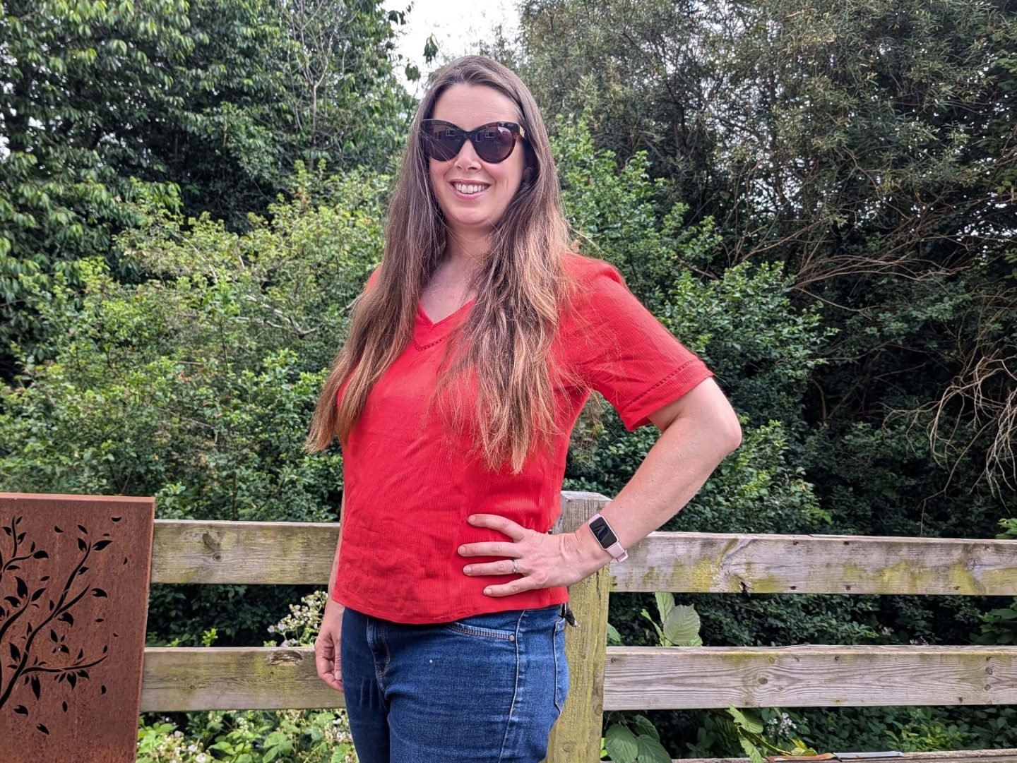 Natalie wearing a bright red blouse with short sleeves