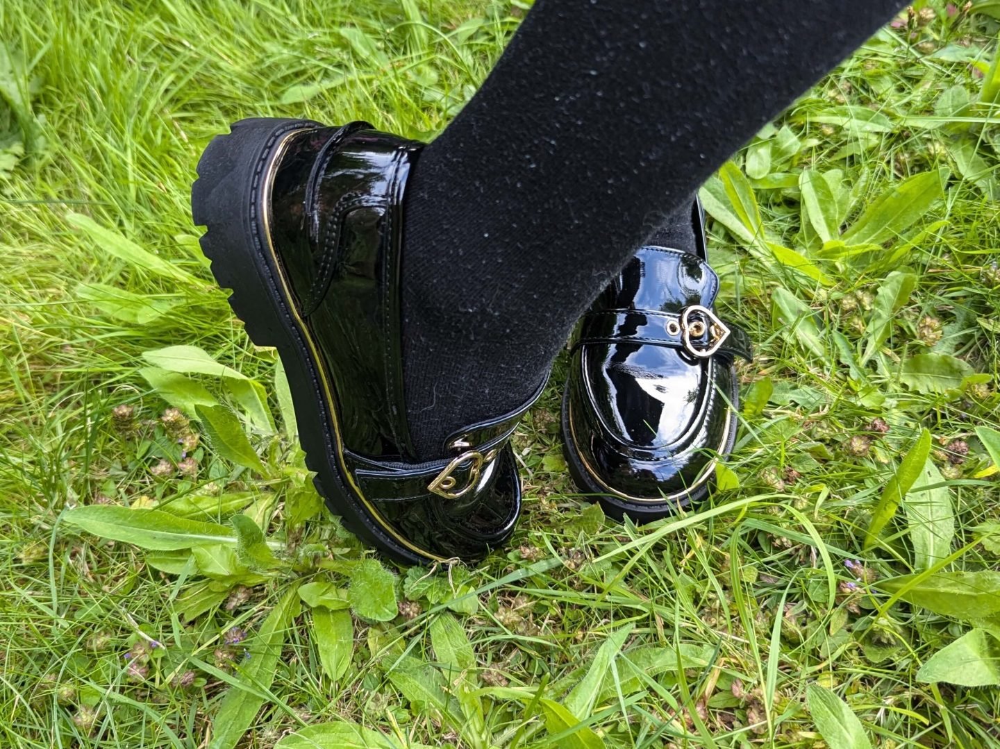 Black patent school shoes with gold trim and gold hearts on top