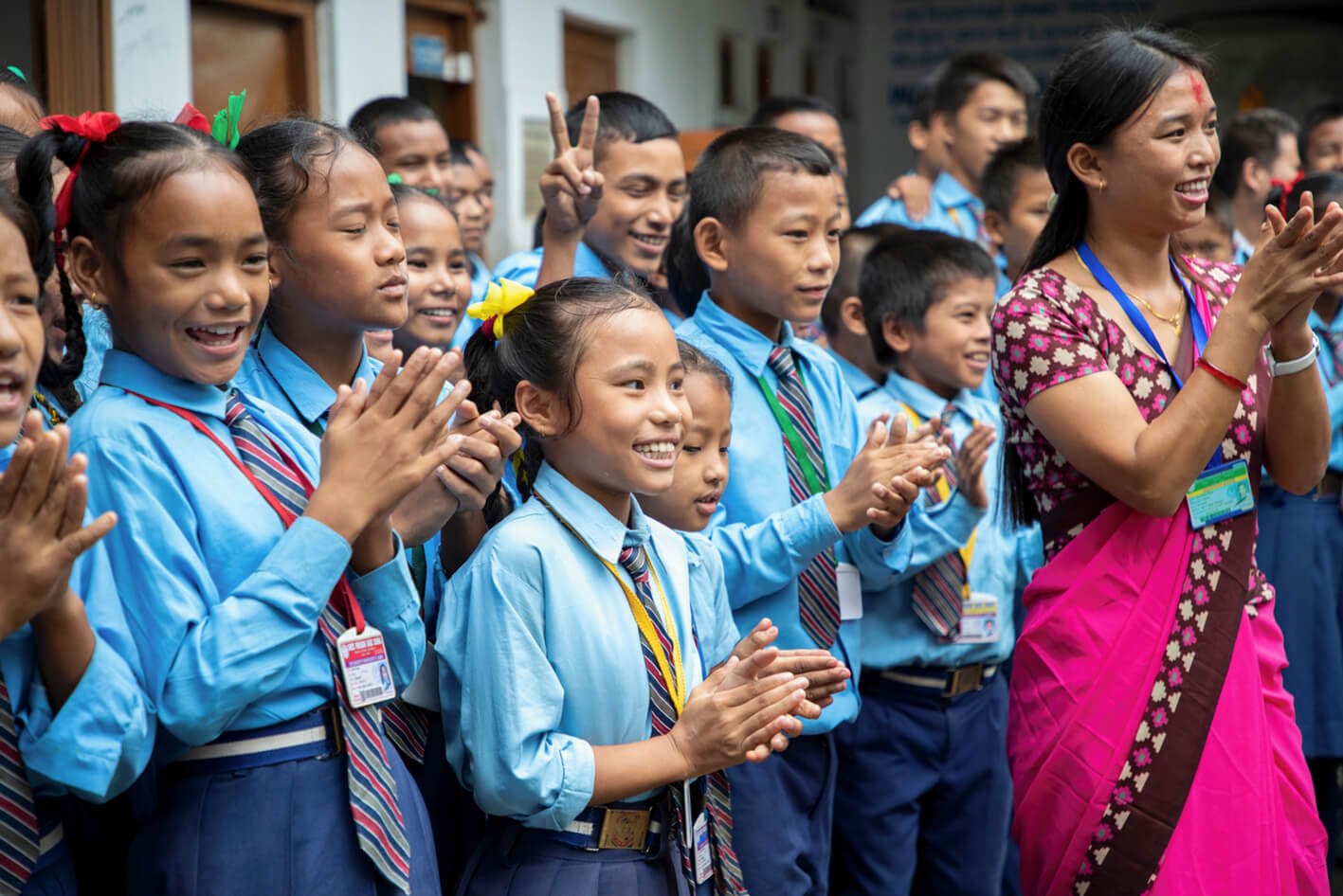 Children at a school in nepal wearing a blue uniform with tie