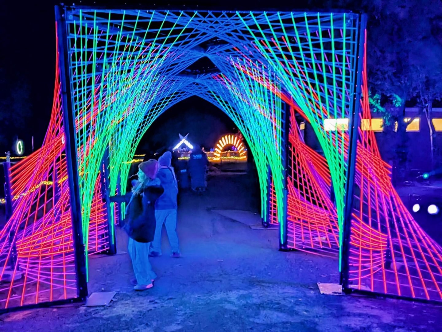 Libby & Lia under a fluorescent light display